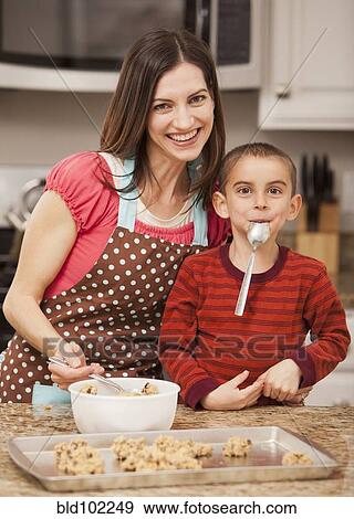 Stock Photo - Caucasian mother and son baking cookies. Fotosearch