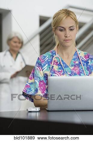 Caucasian nurse using laptop View Large Photo Image Stock Photo - Caucasian nurse using laptop. Fotosearch