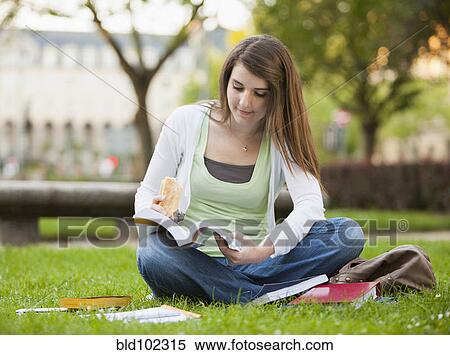 Caucasian student sitting in grass studying View Large Photo Image Stock Photography - Caucasian student sitting in grass studying. Fotosearch