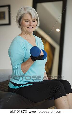 Caucasian woman exercising with hand weights View Large Photo Image Stock Image - Caucasian woman exercising with hand weights. Fotosearch