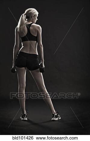 Caucasian woman exercising with hand weights View Large Photo Image Stock Photograph - Caucasian woman exercising with hand weights. Fotosearch