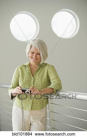 Caucasian woman looking at digital tablet View Large Photo Image Picture - Caucasian woman looking at digital tablet. Fotosearch