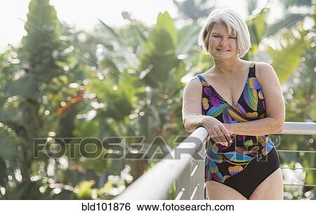 Stock Photograph - Caucasian woman standing in bathing suit. Fotosearch