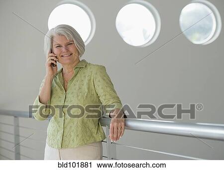Stock Image - Caucasian woman talking on cell phone. Fotosearch