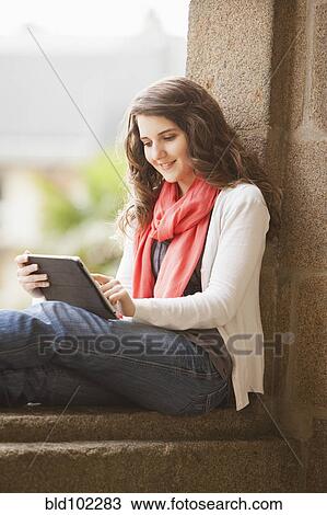 Stock Image - Caucasian woman using digital tablet. Fotosearch