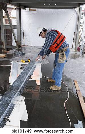 Stock Photo - Caucasian worker on construction site. Fotosearch