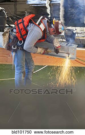 Caucasian worker welding on construction site View Large Photo Image Stock Image - Caucasian worker welding on construction site. Fotosearch