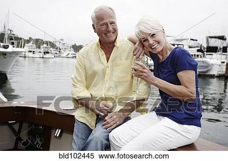 Stock Photography - Couple drinking wine on boat. Fotosearch