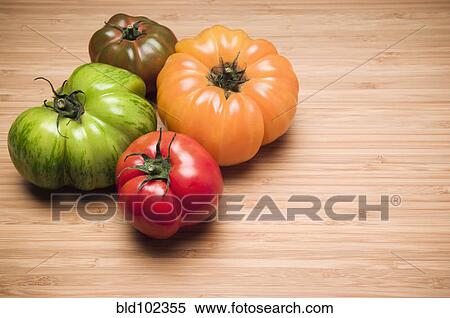 Four colorful tomatoes View Large Photo Image Stock Photography - Four colorful tomatoes. Fotosearch