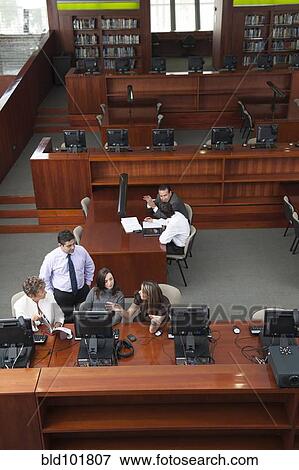 Hispanic business people having meeting in library View Large Photo Image Stock Photo - Hispanic business people having meeting in library. Fotosearch