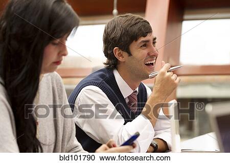 Stock Image - Hispanic business people in meeting. Fotosearch