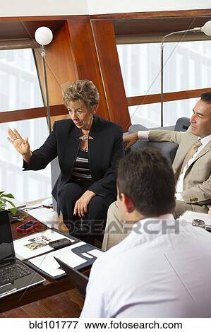 Stock Photo - Hispanic business people in meeting together. Fotosearch