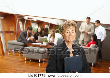 Stock Photo - Hispanic business people in meeting together. Fotosearch