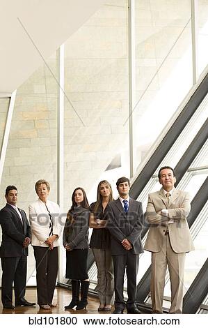 Stock Image - Hispanic business people standing together. Fotosearch
