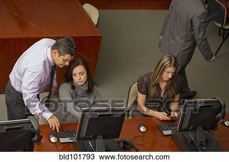 Stock Image - Hispanic business people working together. Fotosearch