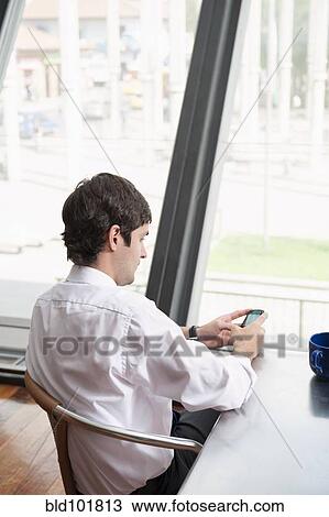 Hispanic businessman text messaging on cell phone View Large Photo Image Stock Image - Hispanic businessman text messaging on cell phone. Fotosearch