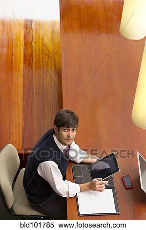 Hispanic businessman using digital tablet View Large Photo Image Stock Photography - Hispanic businessman using digital tablet. Fotosearch
