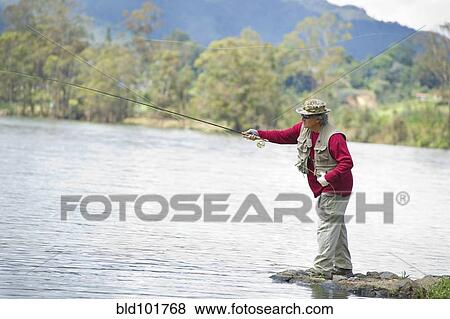 Hispanic man fishing in lake View Large Photo Image Stock Photo - Hispanic man fishing in lake. Fotosearch