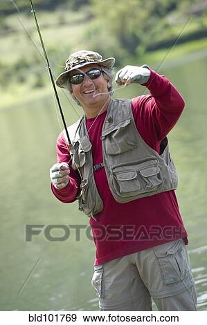 Hispanic man fishing in lake View Large Photo Image Stock Photo - Hispanic man fishing in lake. Fotosearch
