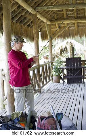 Hispanic man preparing to go fishing View Large Photo Image Stock Image - Hispanic man preparing to go fishing. Fotosearch