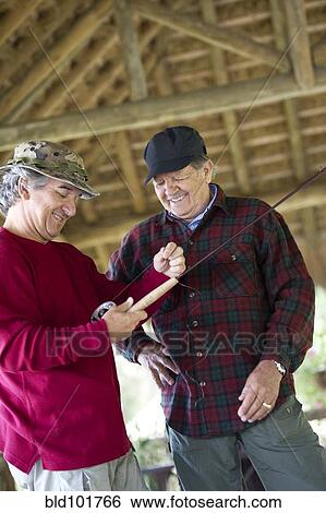 Stock Photograph - Hispanic men preparing to go fishing. Fotosearch