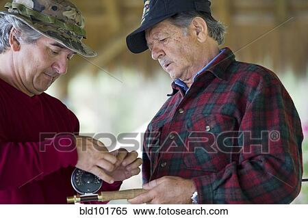 Stock Photography - Hispanic men preparing to go fishing. Fotosearch