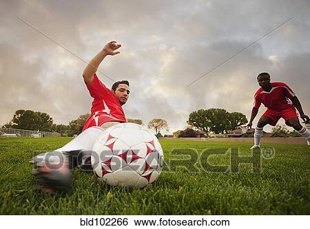 Hispanic soccer player kicking the ball View Large Photo Image Stock Photograph - Hispanic soccer player kicking the ball. Fotosearch