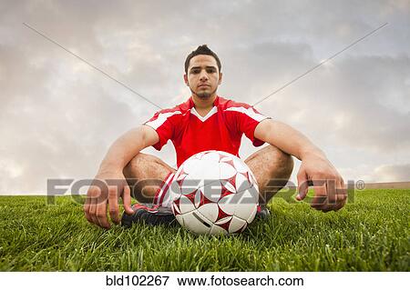 Hispanic soccer player sitting with ball View Large Photo Image Stock Photo - Hispanic soccer player sitting with ball. Fotosearch