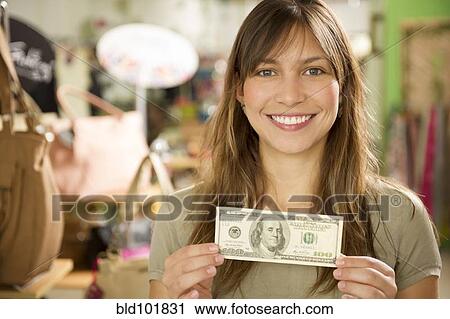 Hispanic woman holding cash in store View Large Photo Image Stock Image - Hispanic woman holding cash in store. Fotosearch