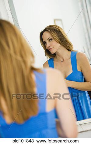 Hispanic woman looking in mirror View Large Photo Image Stock Photo - Hispanic woman looking in mirror. Fotosearch