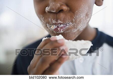 Messy Black boy eating donut View Large Photo Image Stock Image - Messy Black boy eating donut. Fotosearch
