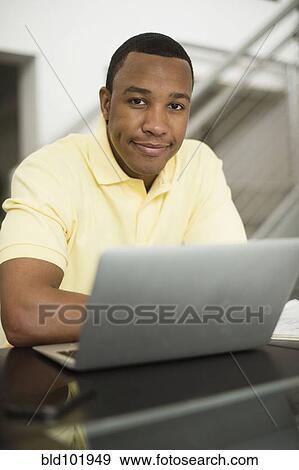Mixed race businessman using laptop View Large Photo Image Stock Photo - Mixed race businessman using laptop. Fotosearch