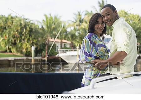 Mixed race couple hugging near waterfront View Large Photo Image Stock Photography - Mixed race couple hugging near waterfront. Fotosearch