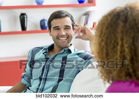Stock Image - Mixed race couple talking together. Fotosearch