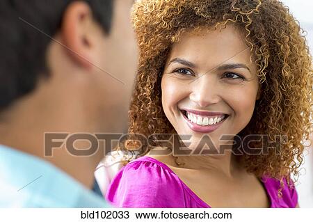 Stock Image - Mixed race couple talking together. Fotosearch