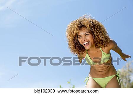 Stock Photo - Mixed race woman in bikini. Fotosearch