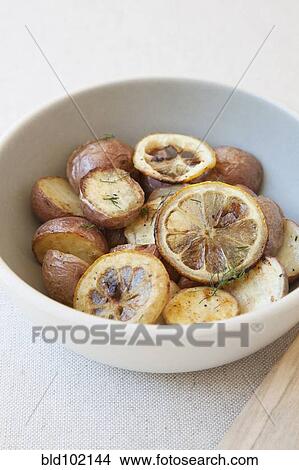 Potatoes and lemon in bowl View Large Photo Image Picture - Potatoes and lemon in bowl. Fotosearch