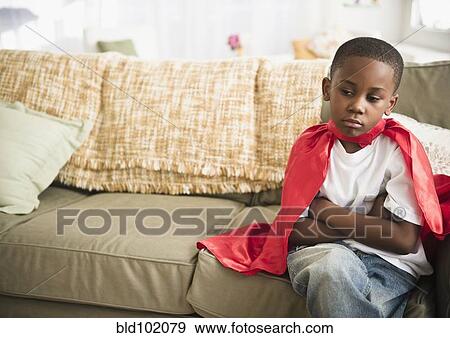 Stock Photo - Pouting black boy in superhero cape. Fotosearch