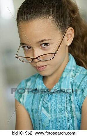 Serious Hispanic girl in eyeglasses View Large Photo Image Stock Image - Serious Hispanic girl in eyeglasses. Fotosearch