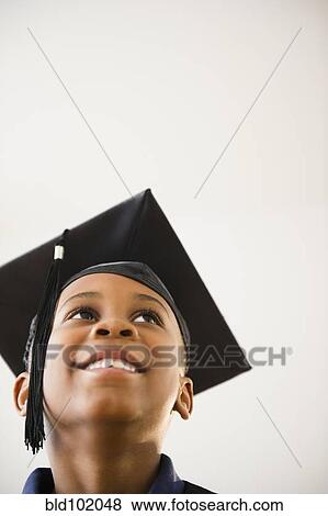 Smiling Black boy in graduation cap View Large Photo Image Stock Photo - Smiling Black boy in graduation cap. Fotosearch
