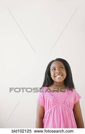 Stock Photography - Smiling Black girl looking up. Fotosearch