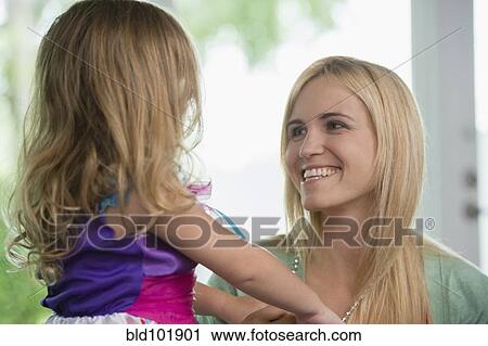 Stock Image - Smiling Caucasian mother and daughter. Fotosearch