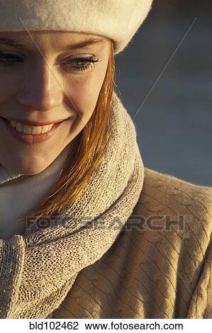 Stock Image - Smiling Caucasian woman in scarf. Fotosearch