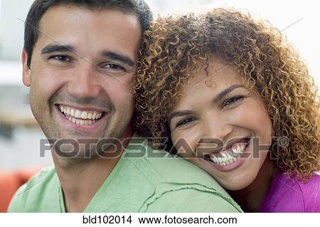 Picture - Smiling mixed race couple. Fotosearch