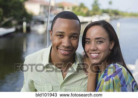 Stock Image - Smiling mixed race couple. Fotosearch