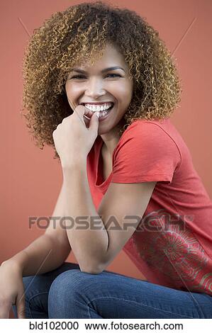Stock Image - Smiling mixed race woman. Fotosearch