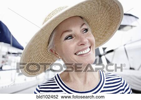 Stock Image - Smiling woman enjoying marina. Fotosearch