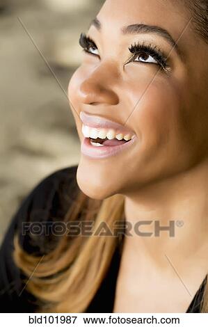 Smiling woman looking up View Large Photo Image Stock Photo - Smiling woman looking up. Fotosearch