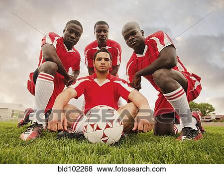Soccer players posing with ball View Large Photo Image Stock Photo - Soccer players posing with ball. Fotosearch