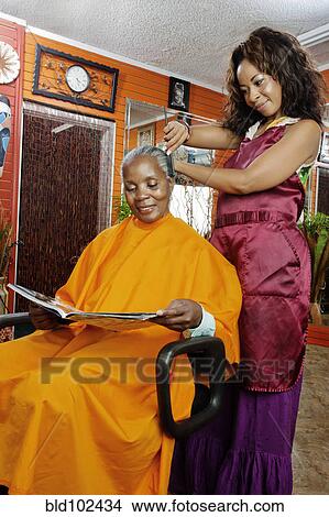 Picture - Woman having hair done in beauty salon. Fotosearch